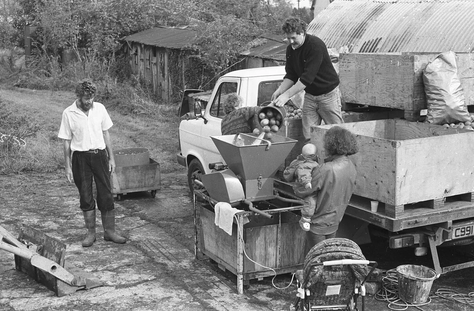 Keith tips in a bucket of apples, from Cider Making in Black and White, Stuston, Suffolk - 11th October 1992