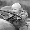 Monique's baby pretends to drive, Cider Making in Black and White, Stuston, Suffolk - 11th October 1992