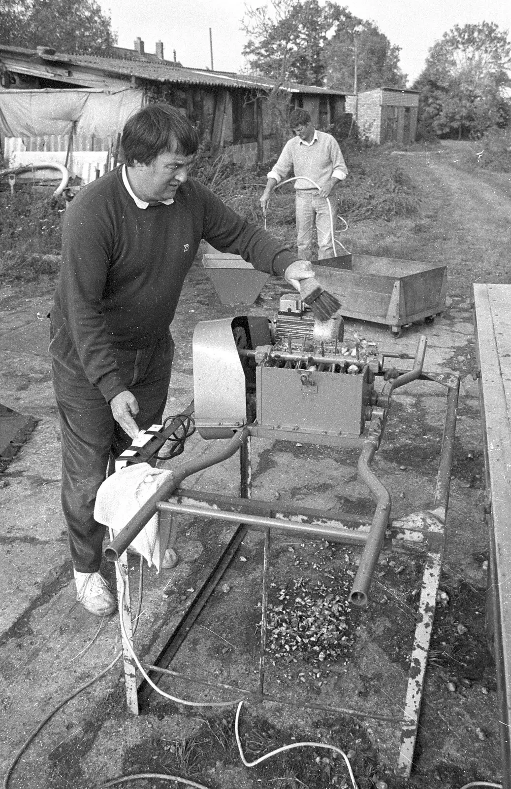 Corky cleans the chopper blades, from Cider Making in Black and White, Stuston, Suffolk - 11th October 1992