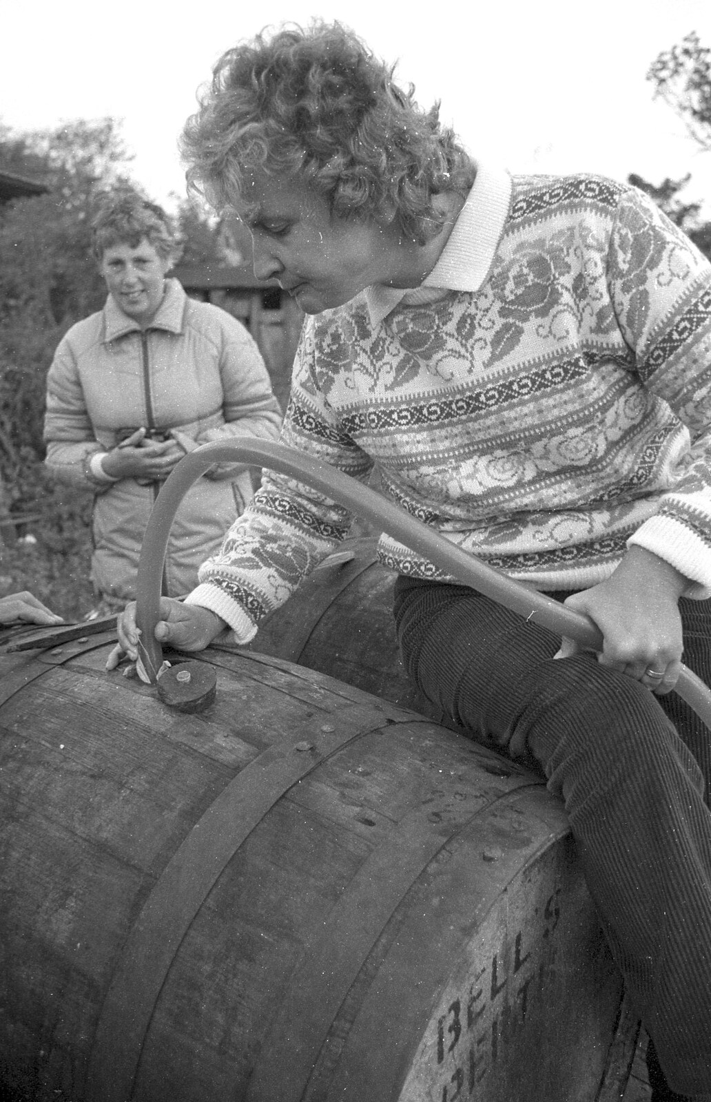 Linda feeds apple juice into a barrel from Cider Making in Black and White, Stuston, Suffolk - 11th October 1992
