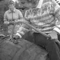 Linda feeds apple juice into a barrel, Cider Making in Black and White, Stuston, Suffolk - 11th October 1992