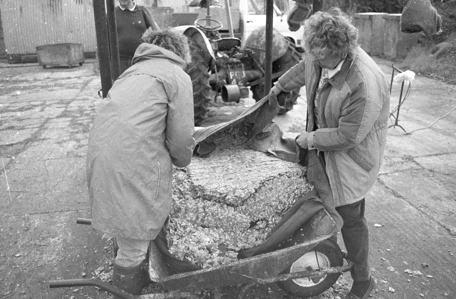 The compressed waste apple is tipped out, from Cider Making in Black and White, Stuston, Suffolk - 11th October 1992