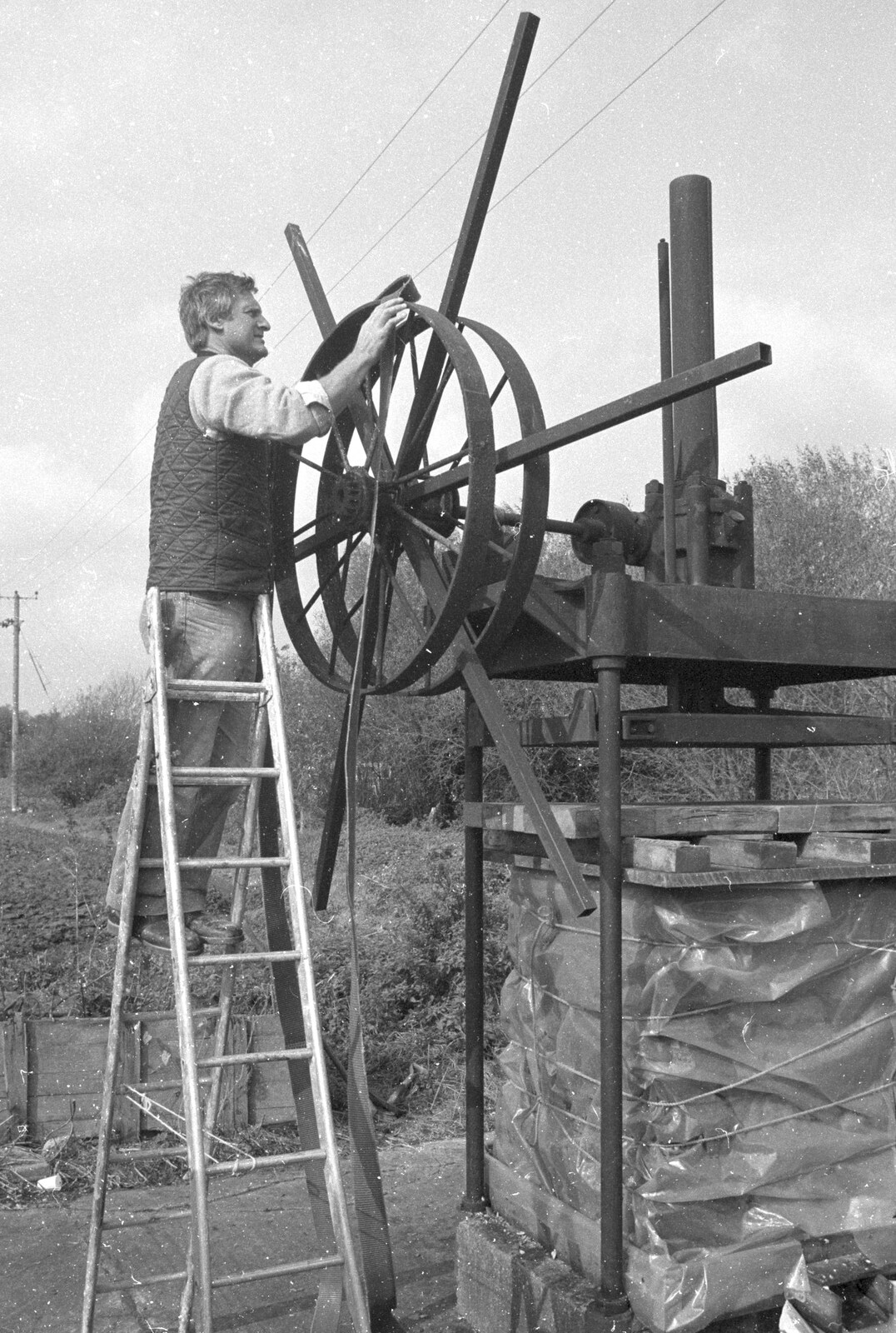 Geoff straps up the drive belt from Cider Making in Black and White, Stuston, Suffolk - 11th October 1992