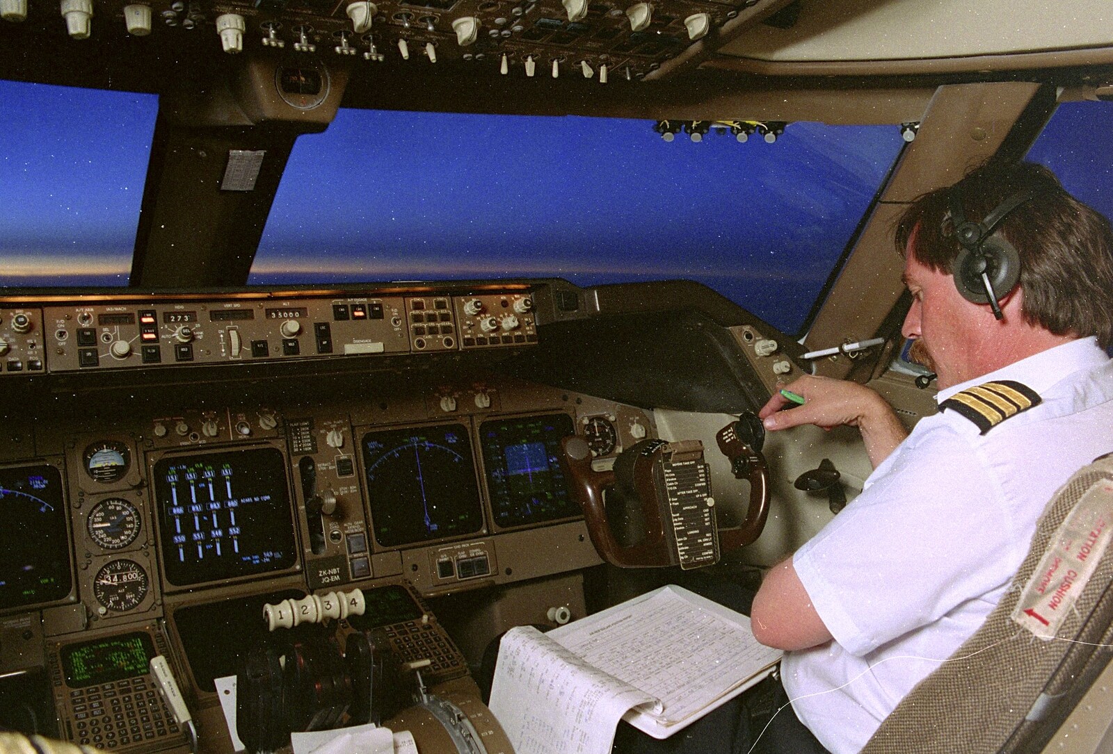 The co-pilot does paperwork at 35,000 feet, heading west from A 747 Cockpit, Honolulu and Pearl Harbor, O'ahu, Hawai'i, United States - 20th November 1992
