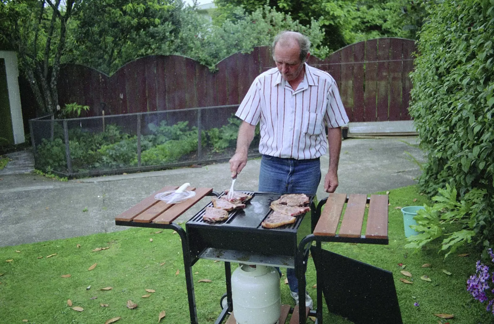 Clive turns some chops over, from Ferry Landing, Whitianga, New Zealand - 23rd November 1992