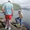 Clive climbs the rocks with a fish in tow, Ferry Landing, Whitianga, New Zealand - 23rd November 1992