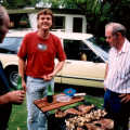 Clive (right) mans the barbeque. Steve grins.