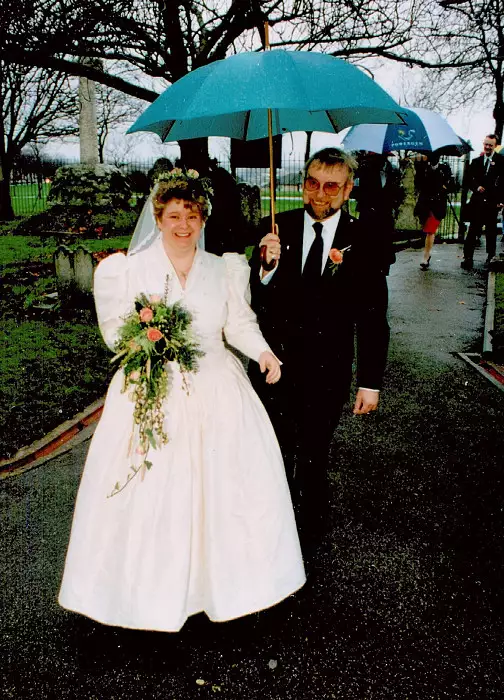 Anna heads into the church as her dad holds the umbrella, from Anna and Chris's Wedding, Southampton - December 1992