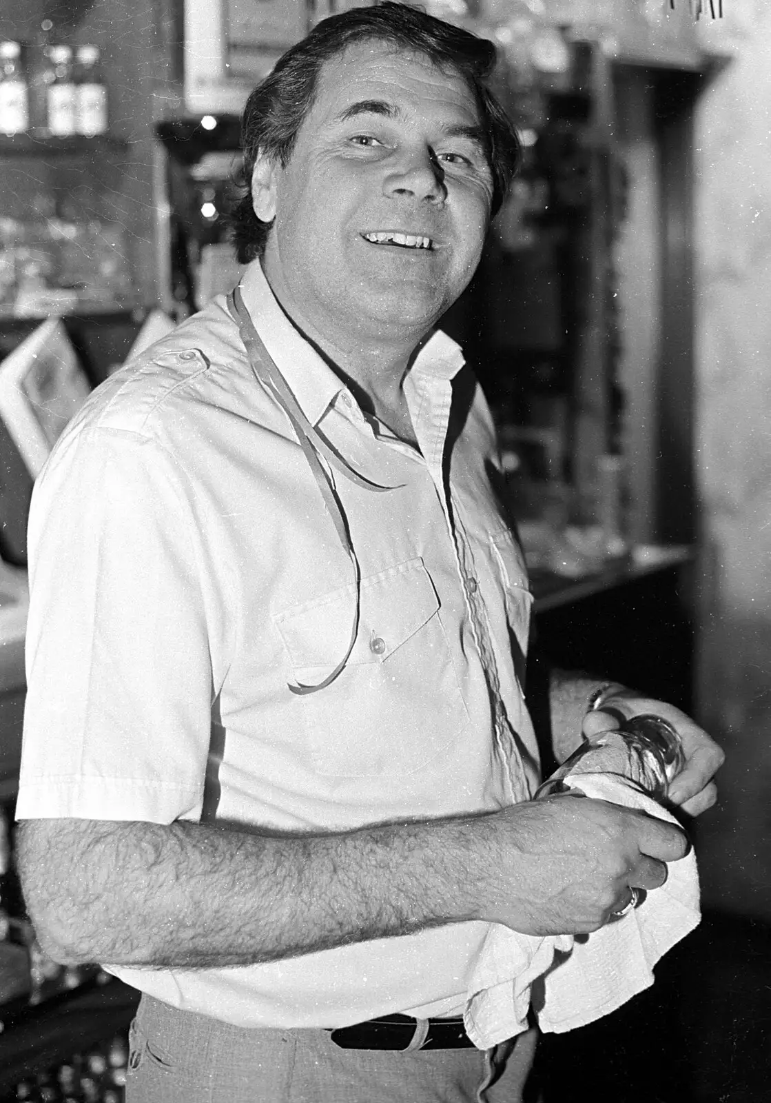 Alan looks over as he wipes a glass, from New Year's Eve at the Swan Inn, Brome, Suffolk - 31st December 1992