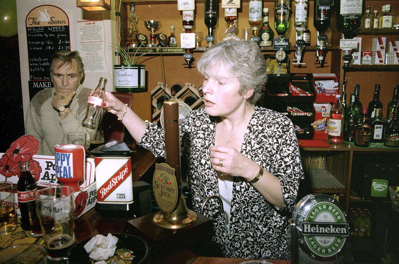 A Night In The Swan Inn, Brome, Suffolk - 1st November 1993: Spammy picks up an empty Coke bottle as Tony Guy looks puzzled