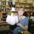 Lorraine holds up a ceramic swan, A Night In The Swan Inn, Brome, Suffolk - 1st November 1993