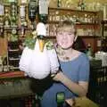 Lorraine holds up a ceramic swan, A Night In The Swan Inn, Brome, Suffolk - 1st November 1993