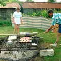 Geoff pokes the massive barbeque pit, A Geoff and Brenda Barbeque, Stuston, Suffolk - 3rd April 1994