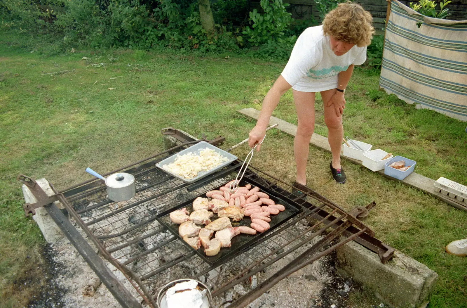 Brenda turns some sausages, from A Geoff and Brenda Barbeque, Stuston, Suffolk - 3rd April 1994