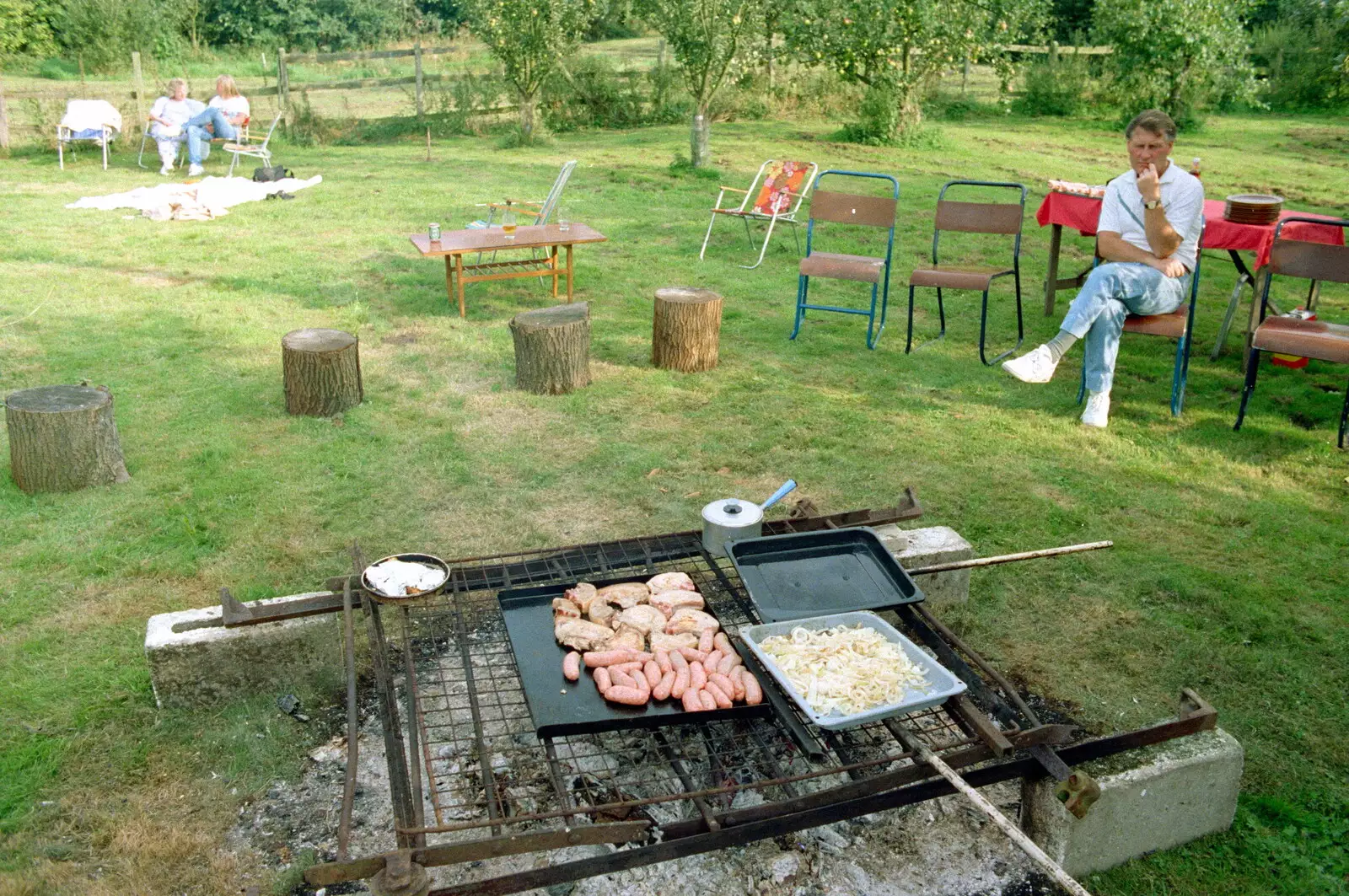 Bernie warily scopes out the sausages, from A Geoff and Brenda Barbeque, Stuston, Suffolk - 3rd April 1994