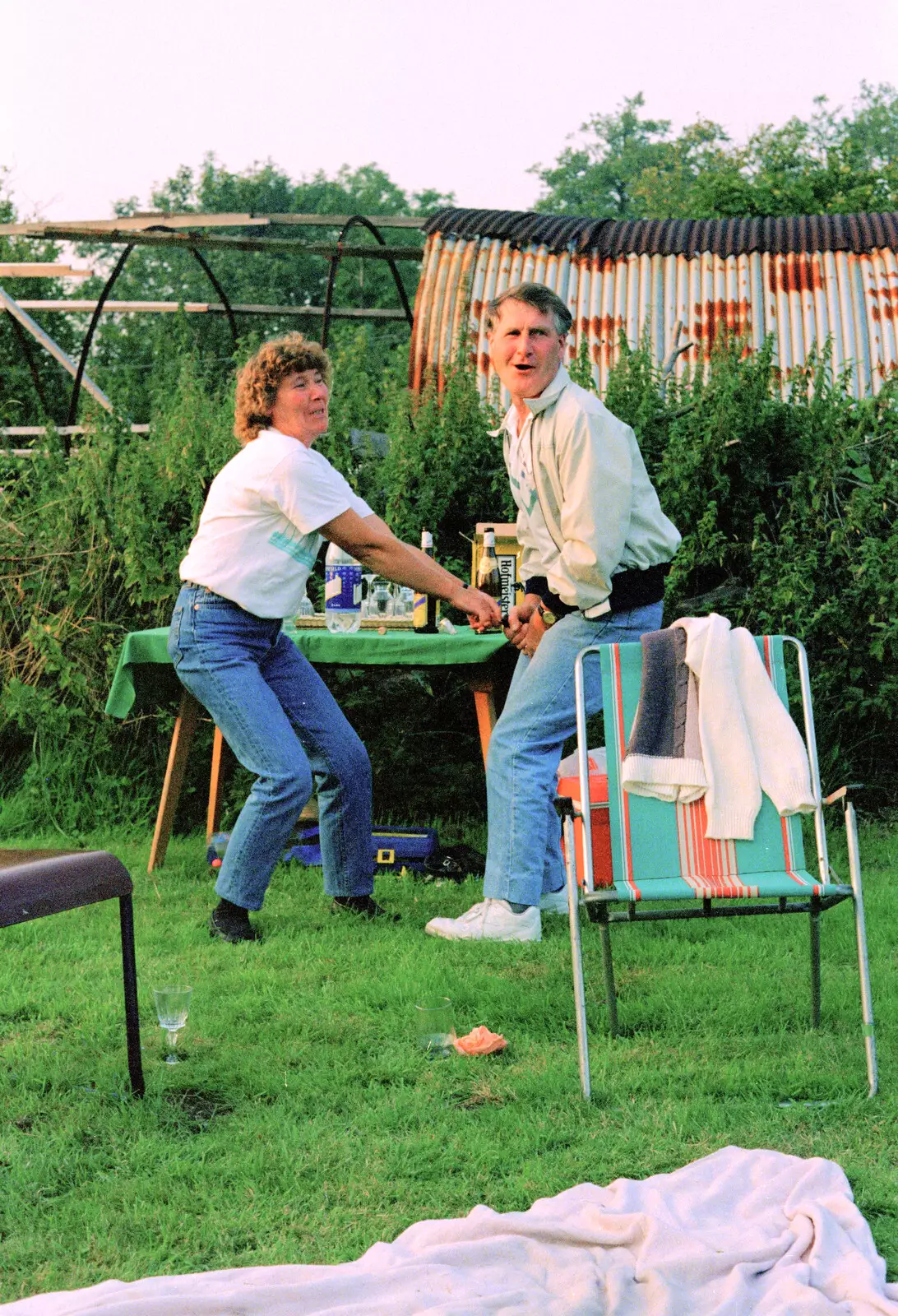 Brenda pops Bernie's cork, from A Geoff and Brenda Barbeque, Stuston, Suffolk - 3rd April 1994