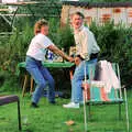 Brenda pops Bernie's cork, A Geoff and Brenda Barbeque, Stuston, Suffolk - 3rd April 1994