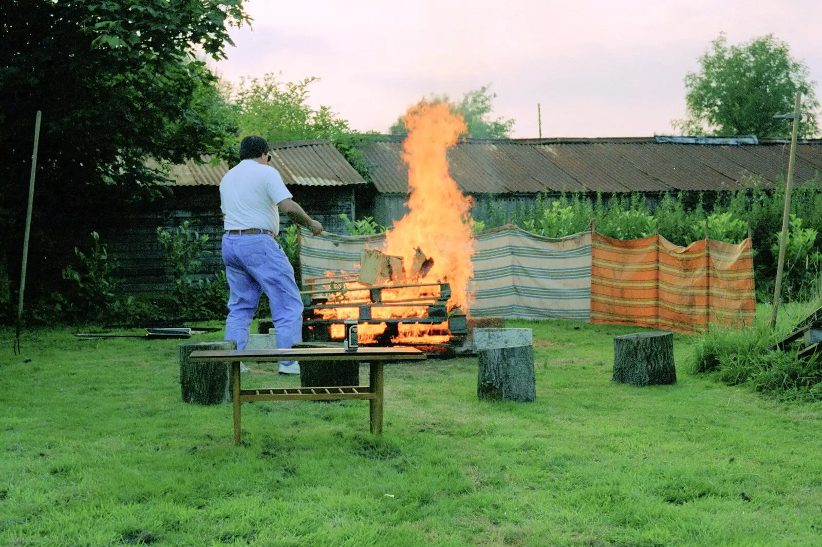 Corky helps 'clean' the barbeque with fire, from A Geoff and Brenda Barbeque, Stuston, Suffolk - 3rd April 1994