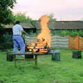 Corky helps 'clean' the barbeque with fire, A Geoff and Brenda Barbeque, Stuston, Suffolk - 3rd April 1994