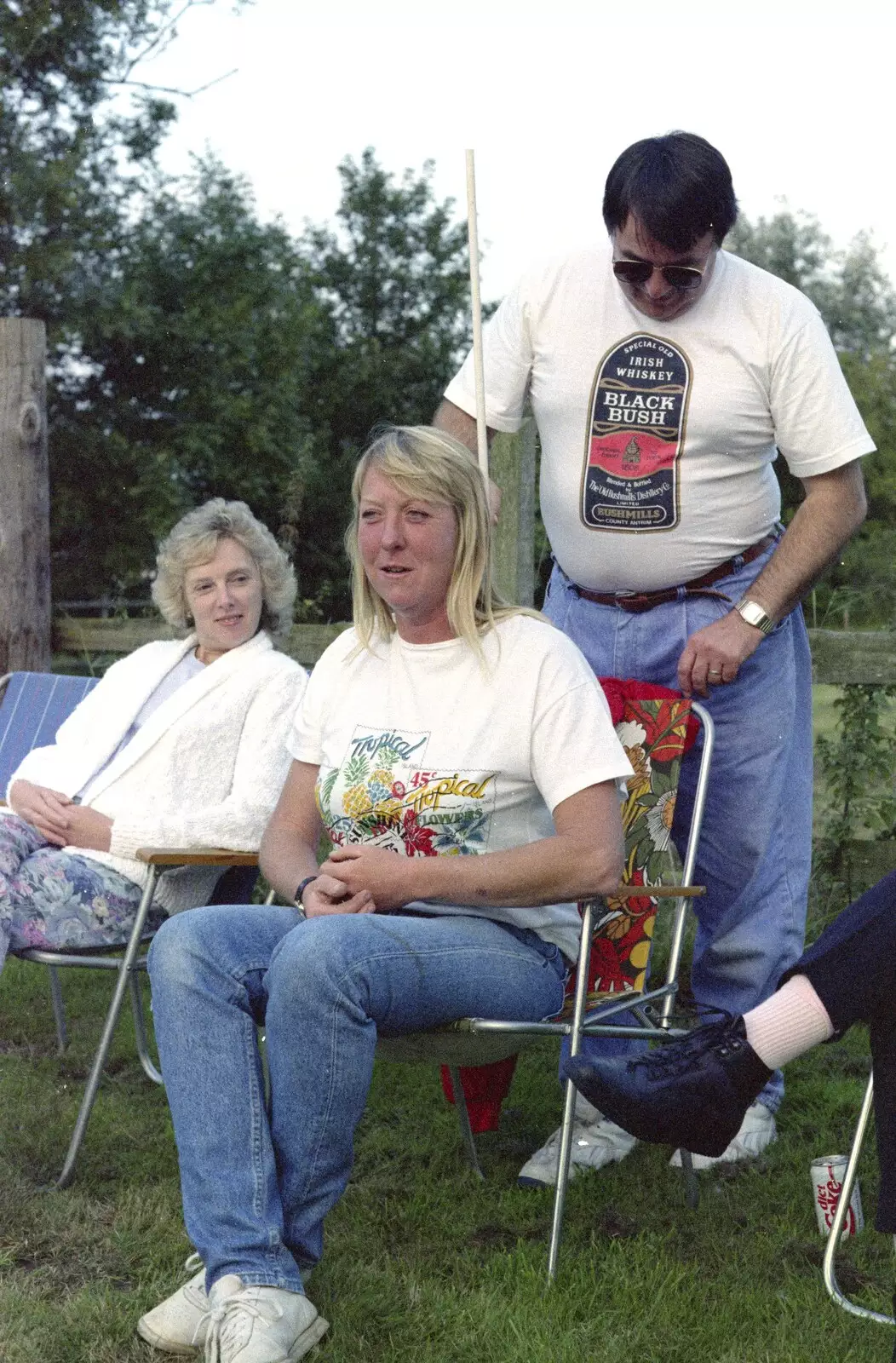 Corky pokes a stick down Sue's back, from A Geoff and Brenda Barbeque, Stuston, Suffolk - 3rd April 1994