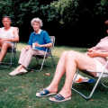 Bruno, Grandmother and Judith sit on camping chairs in the New Forest