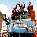 The cup is held aloft on the open-top bus
