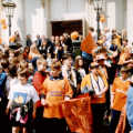 A tangerine crowd waits outside the Cornhall
