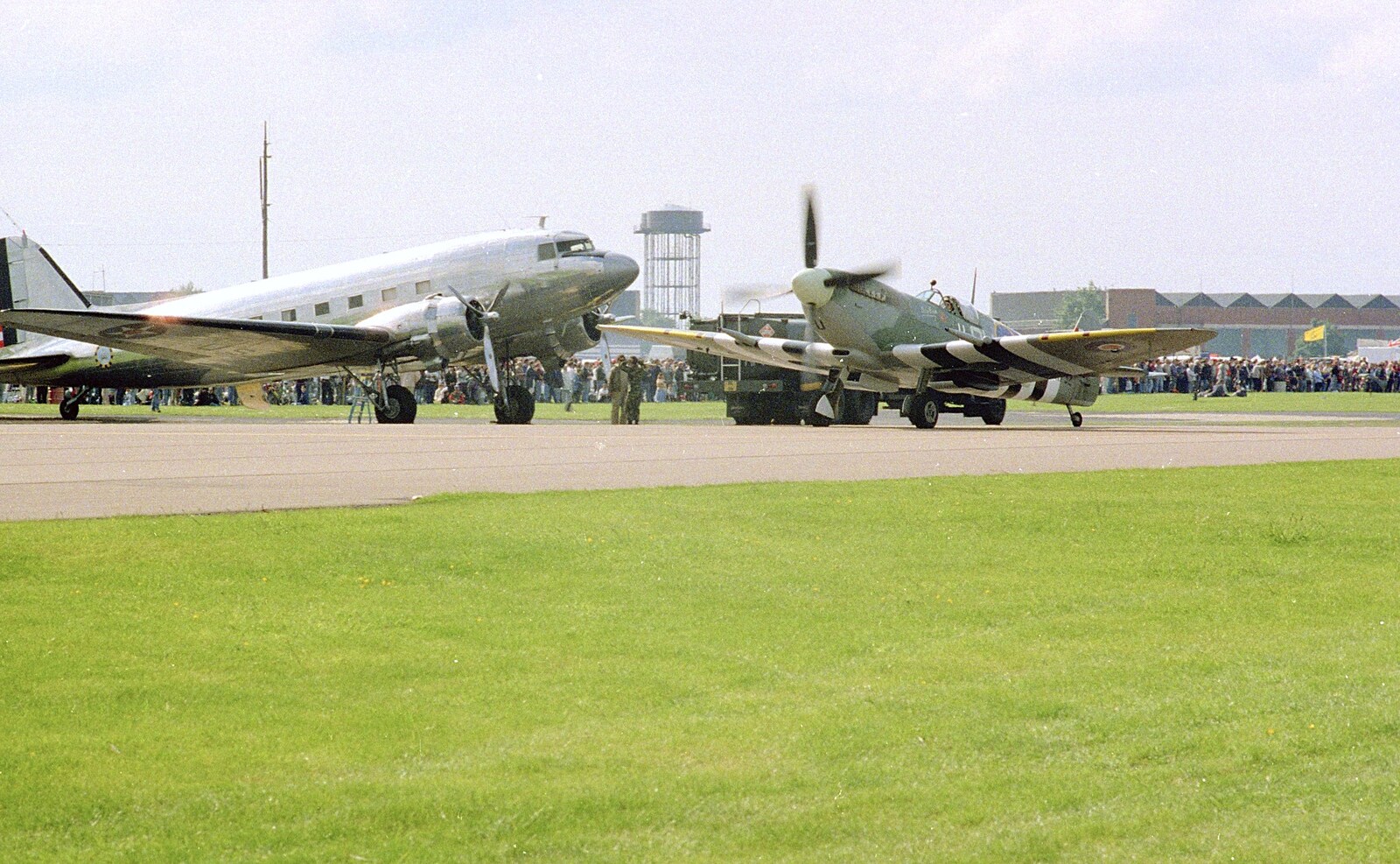 A Douglas DC3 'Dakota' and a taxiing Spitfire from The Mildenhall Air Fete, Mildenhall, Suffolk - 29th May 1994