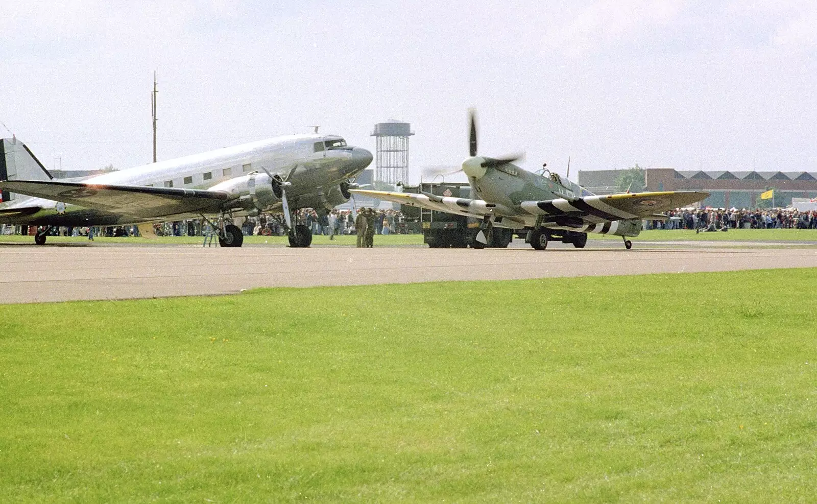 A Douglas DC3 'Dakota' and a taxiing Spitfire, from The Mildenhall Air Fete, Mildenhall, Suffolk - 29th May 1994