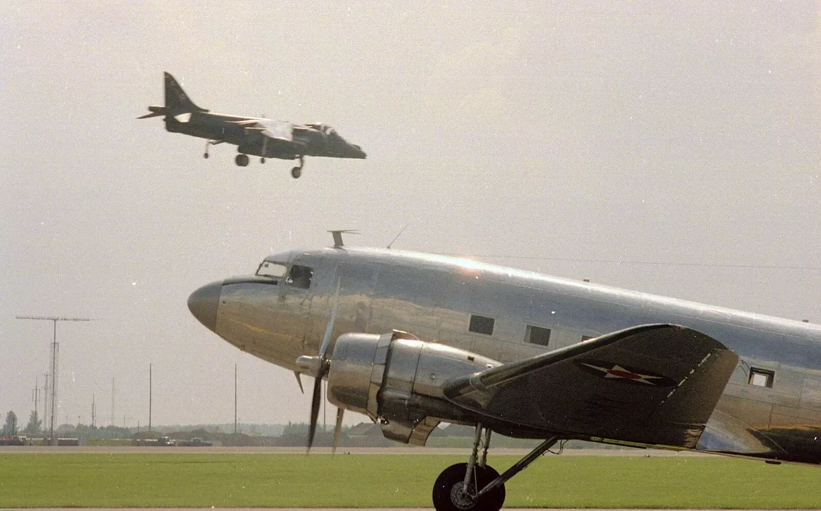 The Harrier flies past a taxiing C-47, from The Mildenhall Air Fete, Mildenhall, Suffolk - 29th May 1994