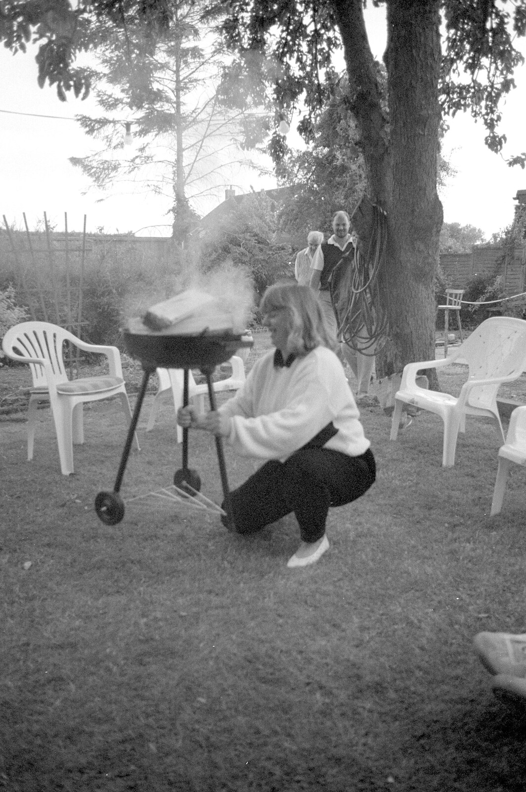 Sarah moves a smoking barbeque around from Sarah's Birthday Barbeque, Burston, Norfolk - 7th June 1994