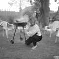 Sarah moves a smoking barbeque around, Sarah's Birthday Barbeque, Burston, Norfolk - 7th June 1994