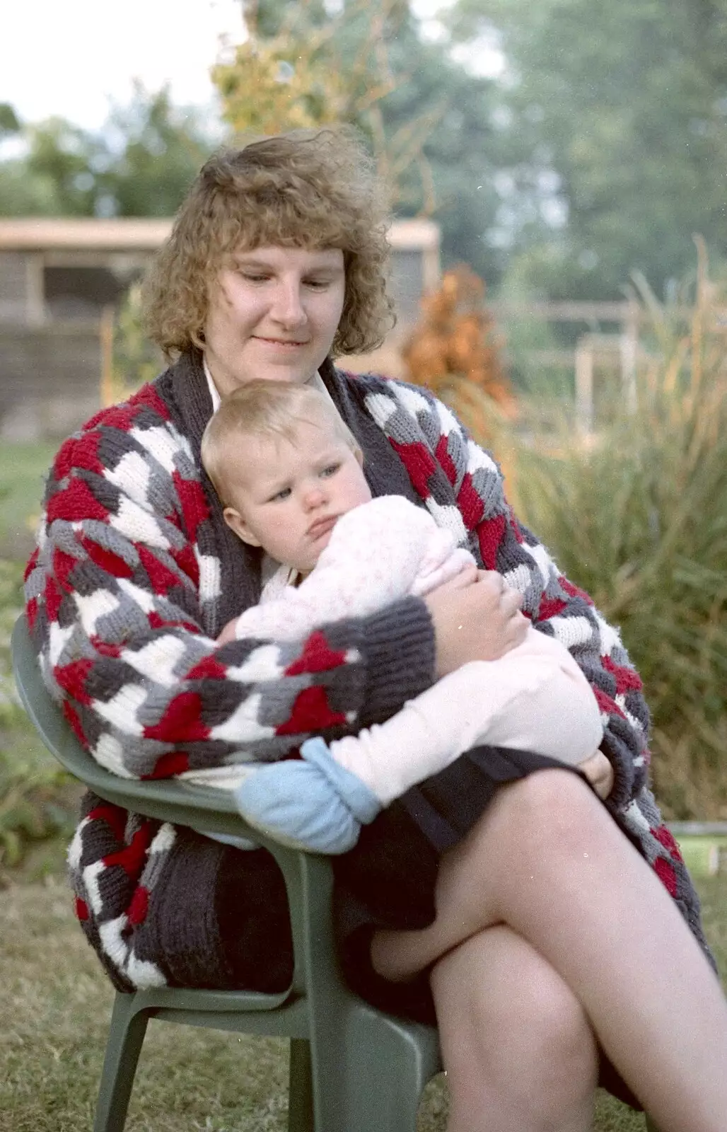 Another sprog gets a cuddle, from Sarah's Birthday Barbeque, Burston, Norfolk - 7th June 1994