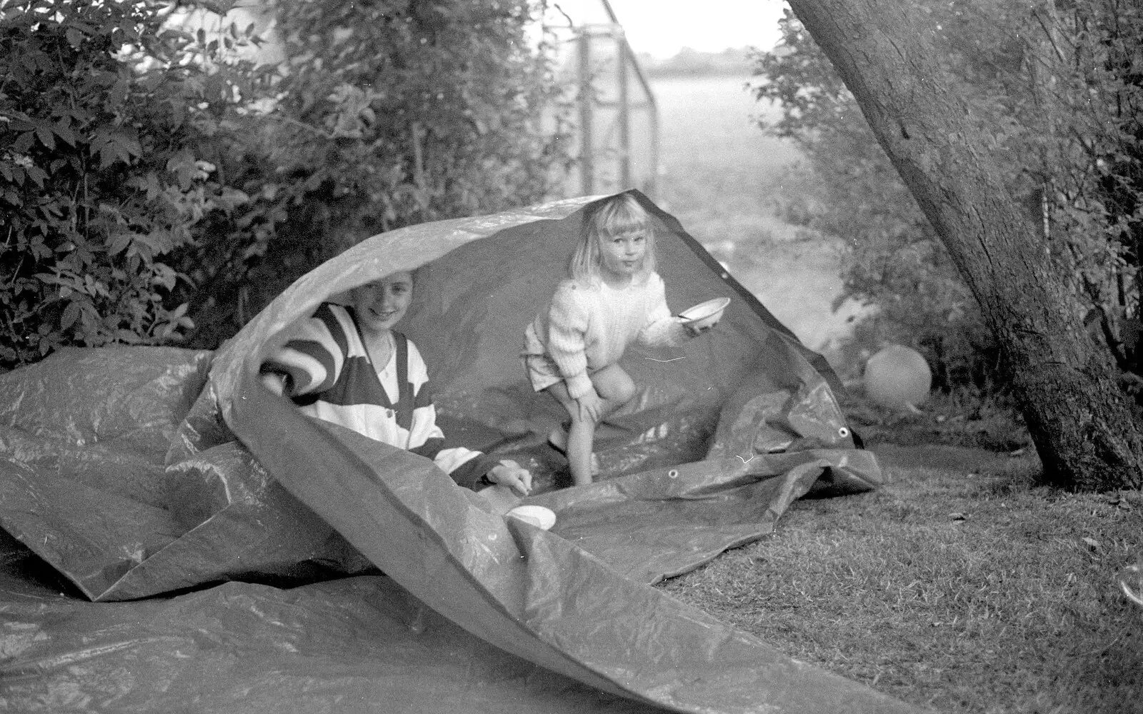 Theresa and sprog in a tarpaulin, from Sarah's Birthday Barbeque, Burston, Norfolk - 7th June 1994