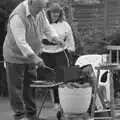 Kenny pokes at some sausages, Sarah's Birthday Barbeque, Burston, Norfolk - 7th June 1994