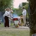 Sarah looks over as Kenny's barbeque smokes, Sarah's Birthday Barbeque, Burston, Norfolk - 7th June 1994