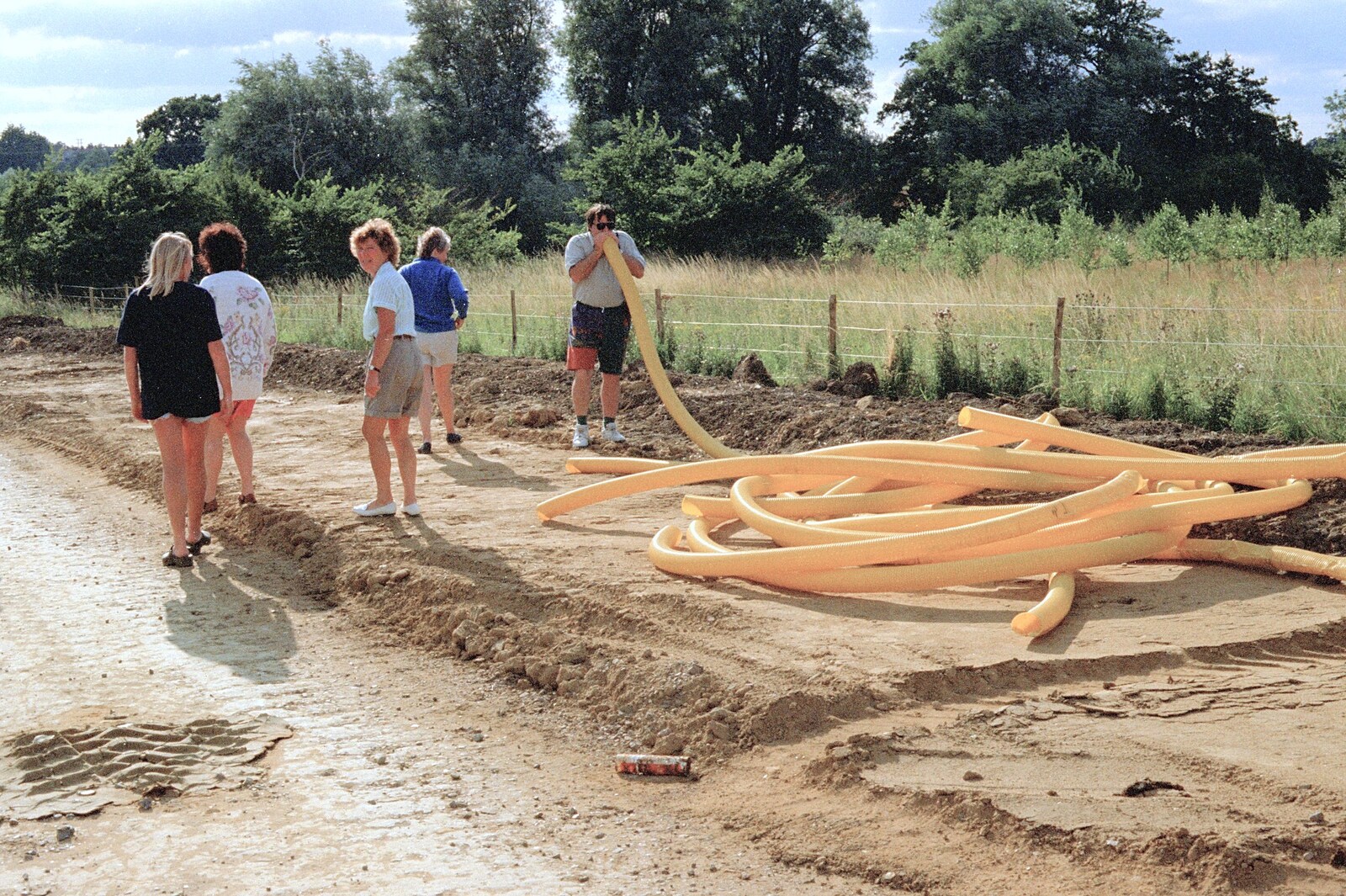 Corky blows down some cabling conduit from "Mad" Sue's 50th and the Building of the Stuston Bypass, Stuston, Suffolk - 7th July 1994