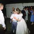 A page boy gets a hug, Bernie's Anniversary and Charlie's Wedding, Palgrave and Oakley, Suffolk - 19th July 1994