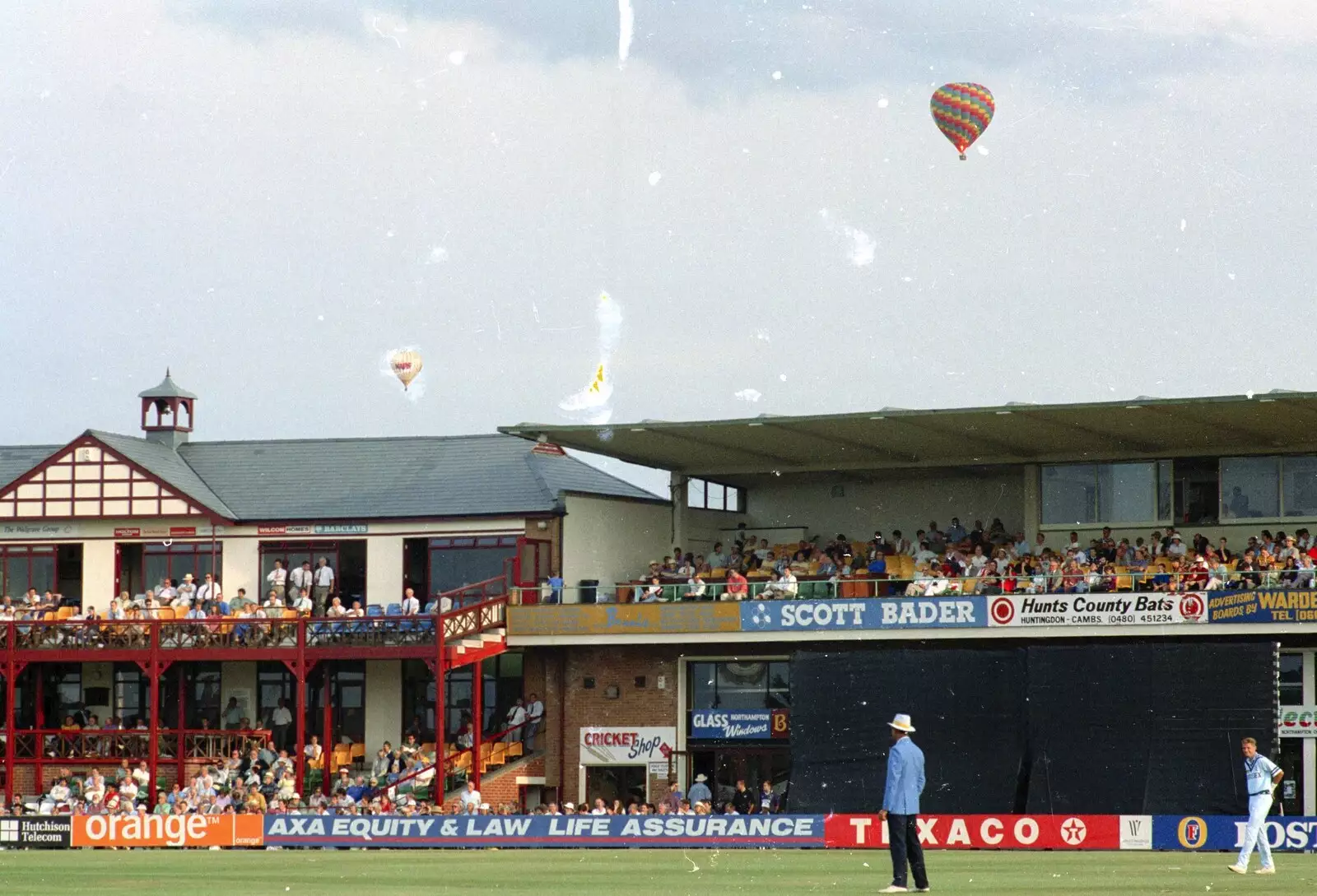 A couple of balloons float over, from A Spot of Cricket, Northampton - 5th September 1994