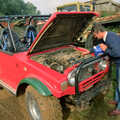 Geoff tops up with some coolant, Off-Roading With Geoff and Brenda, Suffolk - 10th October 1994