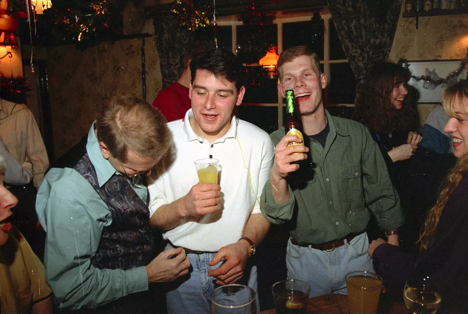 Mikey holds up a bottle of Pils, from New Year's Eve at the Swan Inn, Brome, Suffolk - 31st December 1994