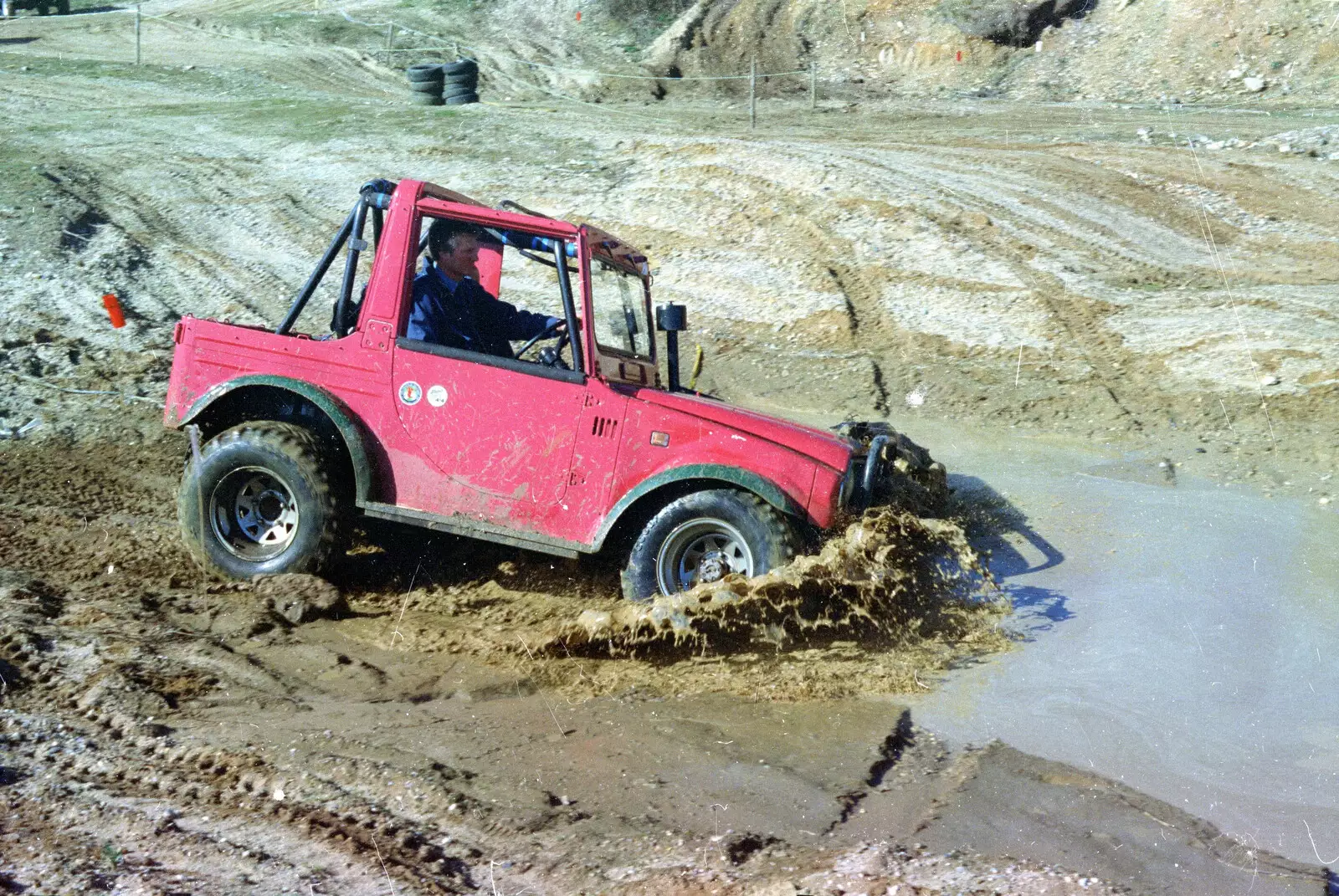 Geoff hits the moddy water, from Off-Roading and The Swan Inn, Brome, Suffolk - 20th May 1995