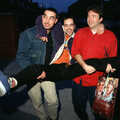1996 Orhan and Tim carry Trev down the street