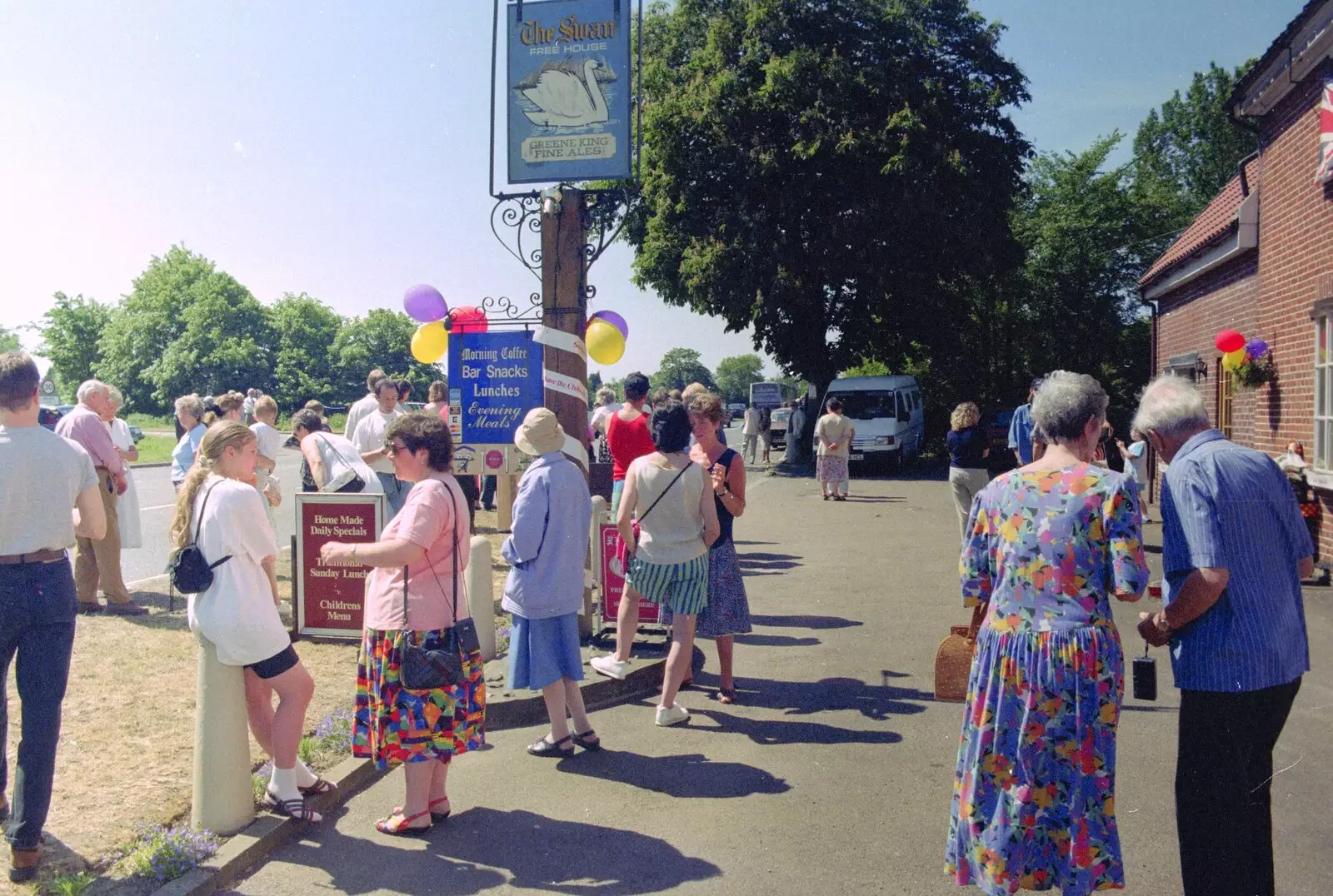 Crowds hang around outside the Swan, from The Norwich Union Mail Coach Run, The Swan Inn, Brome - 15th June 1996