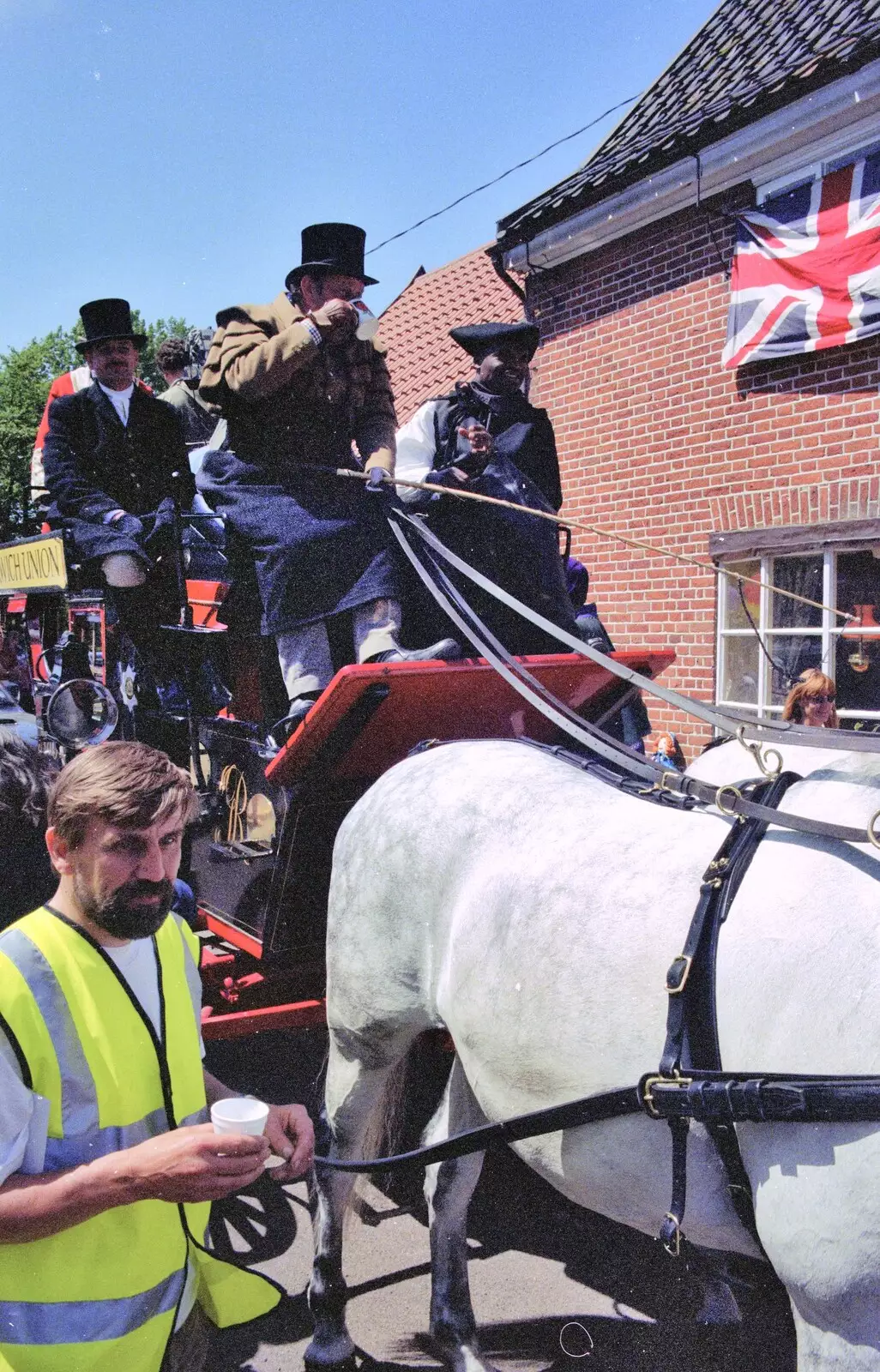 John Parker has a slurp of tea before heading off, from The Norwich Union Mail Coach Run, The Swan Inn, Brome - 15th June 1996