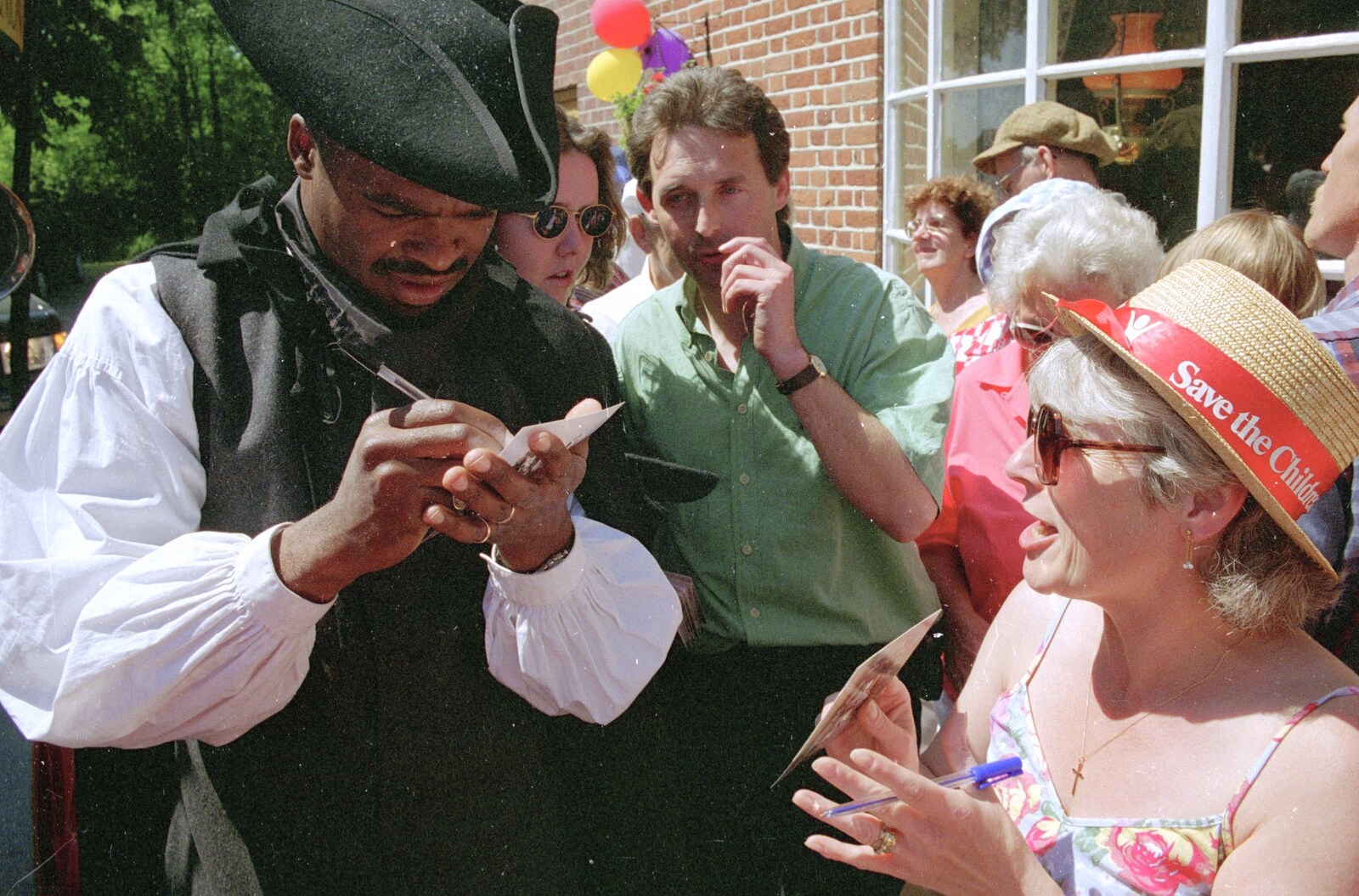 Kris Akabusi signs Spammy's autograph book from The Norwich Union Mail Coach Run, The Swan Inn, Brome - 15th June 1996