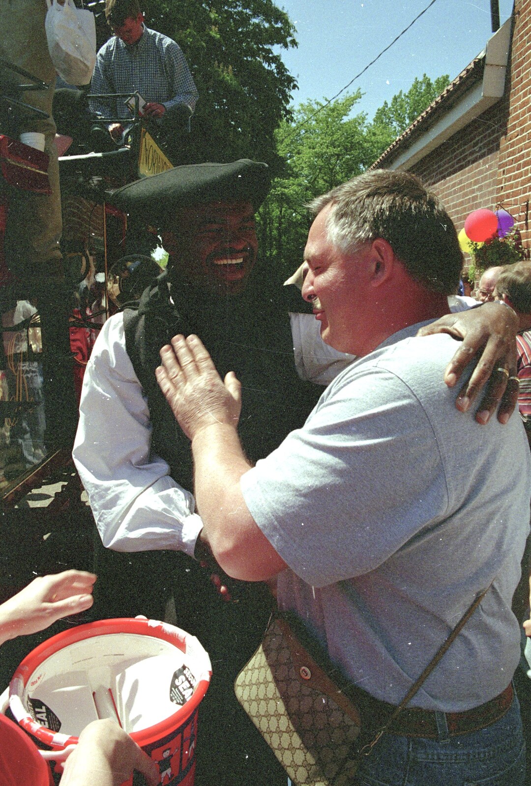 Danny Flint gets a pat on the back from Kris Akabusi from The Norwich Union Mail Coach Run, The Swan Inn, Brome - 15th June 1996