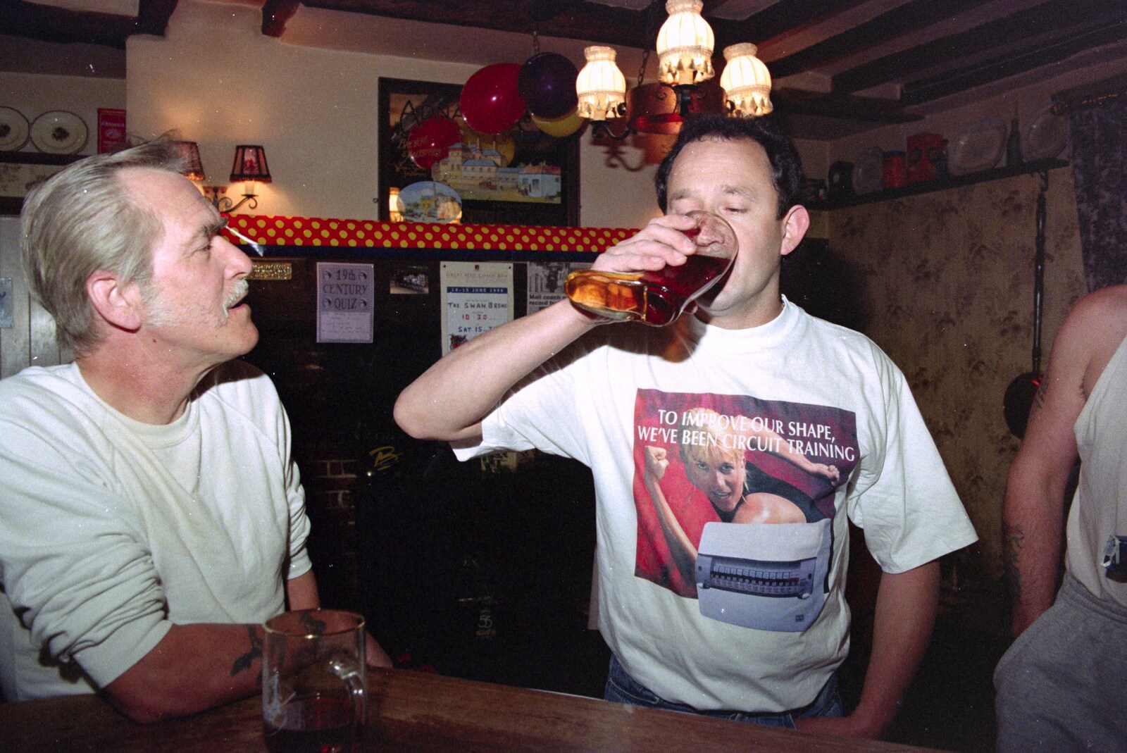 DH has a go on the boot from A Welly Boot of Beer at the Swan Inn, Brome, Suffolk - 15th June 1996