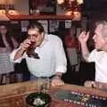 Roger starts his boot, as Tony T-Shirt adds support, A Welly Boot of Beer at the Swan Inn, Brome, Suffolk - 15th June 1996