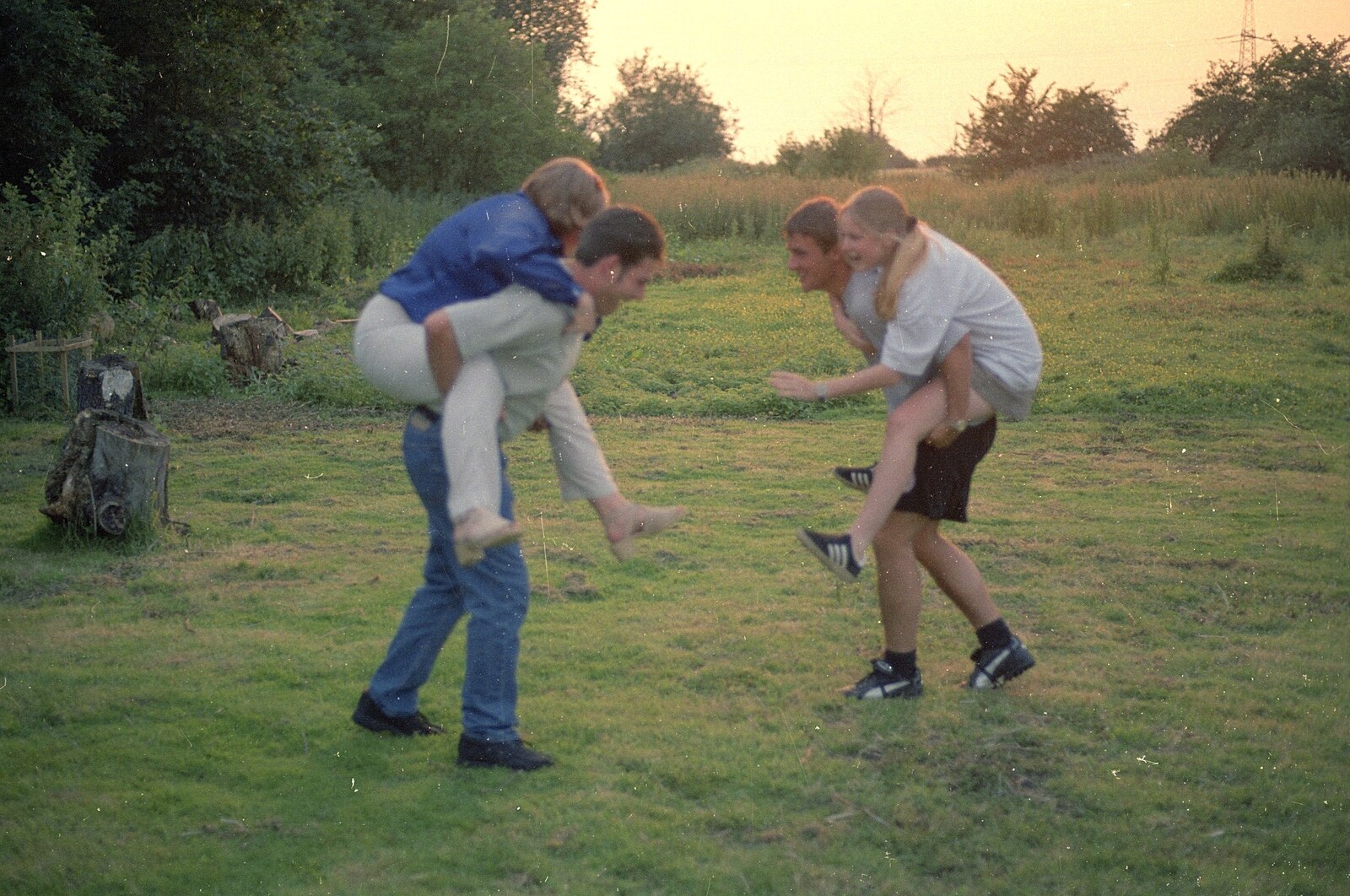 There's some piggy-back action in the garden from DH's Barbeque at The Swan Inn, Brome, Suffolk - July 14th 1996